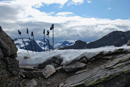 trekking pole in the snow at the top of the norwegian mountainsの写真素材