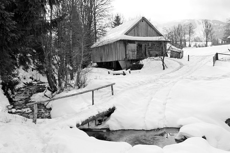 winter landscape house near the road and the bridge over the riverの写真素材