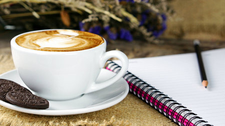 Cappuccino Coffee. A cup of latte, cappuccino or espresso coffee with milk put on a wood table with...