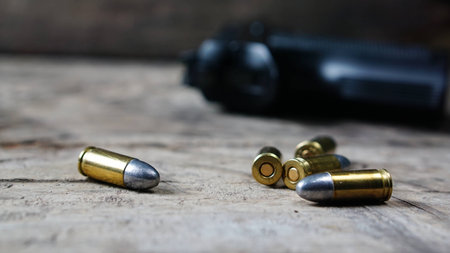 Bullets and a firearm on the wood. Bullets are a projectile expelled from the barrel of a firearm.の写真素材