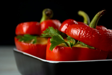 Red stuffed peppers with cheese, tomato, onion and mushroomの写真素材