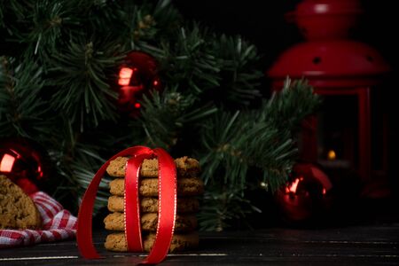 Oatmeal cookies with christmas decoration, candles, christmas treeの写真素材