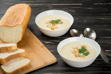 Cheese soup with white bread for two personの写真素材
