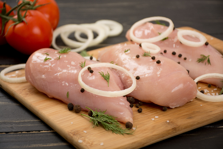 Raw chicken fillet with dill and spiceの写真素材