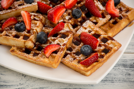Pile of waffles with strawberries and bluberriesの写真素材