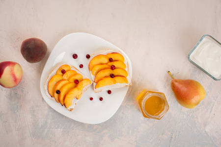 Sweet sandwiches with peaches, yogurt and honeyの写真素材