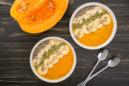 Pumpkin smoothie bowl with pumpkin and chia seeds, bananas and almondsの写真素材
