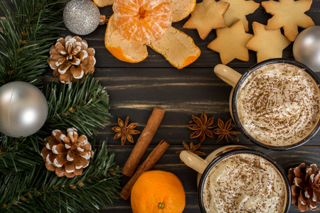 Hot chocolate with whipped cream, cinnamon and some snack, cookies and mandarinsの写真素材