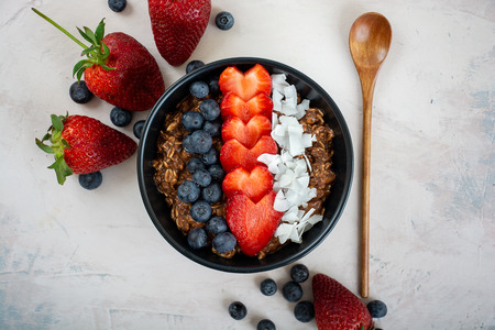 Chocolate overnight oats with fresh berries and coconut, vegan and healthy breakfastの写真素材