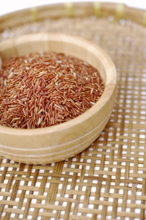 Red rice in wooden bowlの写真素材