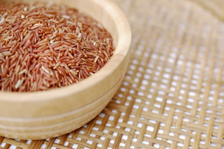 Red rice in wooden bowlの写真素材