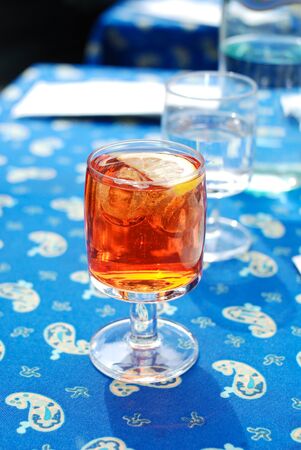 A glass of Spritz Aperol aperitif on blue table cloth, Italyの写真素材
