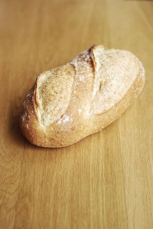 Bread loaf on wooden backgroundの写真素材
