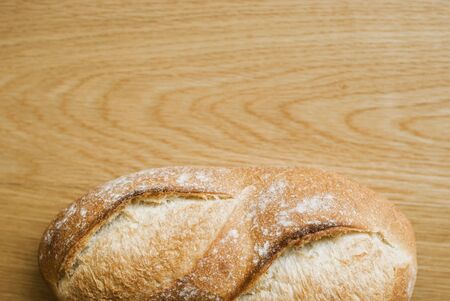 Bread loaf on wooden backgroundの写真素材