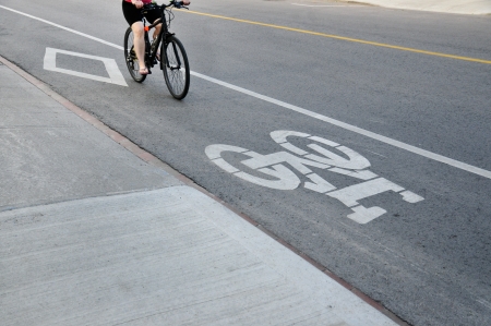 Cyclist riding bicycle in designated bike lane in Torontoの写真素材