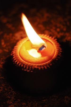 Yellow candle in terracotta pot lit on the occasion of Loy Krathong festival, Thailandの写真素材