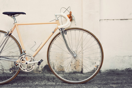 Vintage road bicycle leaning on white wallの写真素材