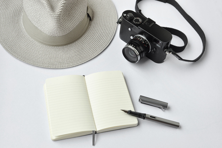 Notebook, pen, and camera, on white background - taken in natural light with strong shodow to create realistic indoor moodの写真素材