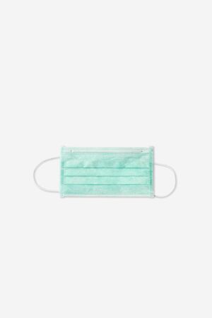 Still life of am unused green face mask on white backgroundの写真素材