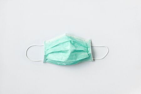 Still life of am unused green face mask on white backgroundの写真素材