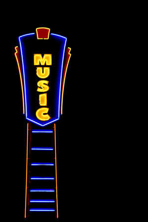 this is a vividly lit neon sign against a black sky depicting music related businessの写真素材