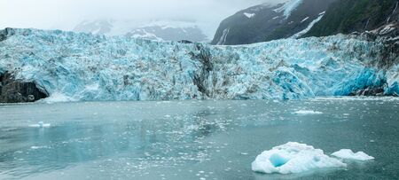 Harriman Glacier in Prince William Sound, Alaska, USA. Chunks of blue ice in the water in the foreground, abundant blue ice on the glacier.の写真素材