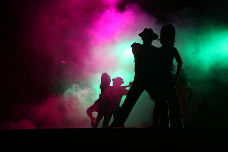 Silhouetted couples performing for theater on stageの写真素材
