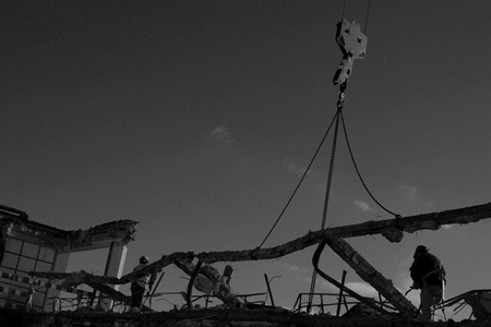 Bulding demolition - men cutting and removing debris