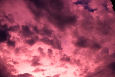 Abstract sunset sky with pink black and purple shining clouds