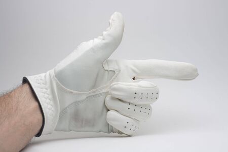 Hand with glove pointing in a directionの写真素材