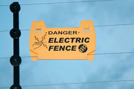 Warning on electric fence to prevent electric shockの写真素材