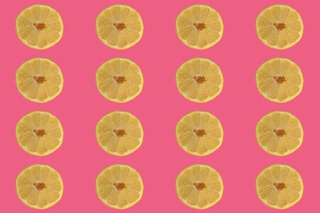 Sliced ?? lemon on a red background, concept for recipes, blog or cookbookの写真素材