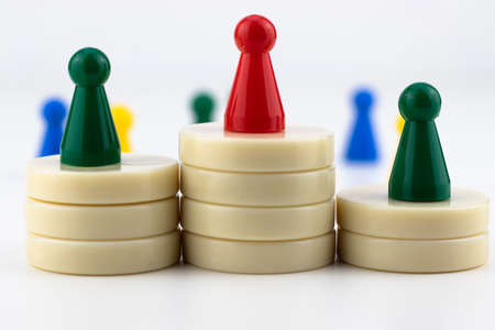 Leadership concept. Colored pawns on a white background.