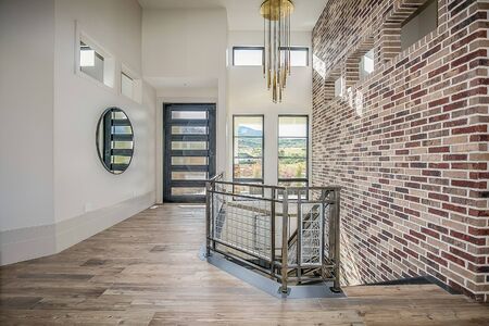 Front entry with a brick wall leading downstairsの写真素材