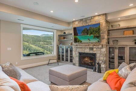 Living room with stone fireplace and awesome mountain views
