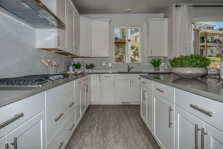 Chef's kitchen with white maple cabinets and granite countertops