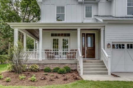 Beautiful front wrap around porch of white newly built home