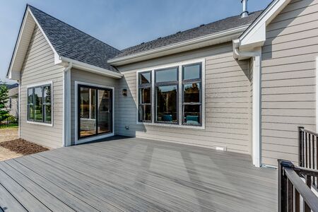 Rear exterior and large empty deck of newly built homeの写真素材