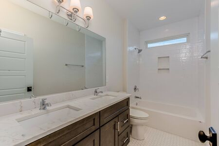 Time enduring white bathroom with brown cabinets