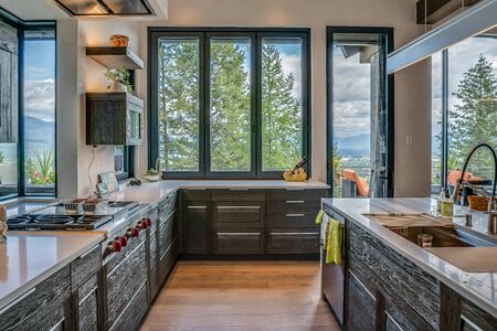 Lots of windows add an outdoor feel to this very modern kitchenの写真素材