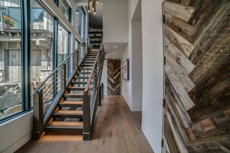 Wide open foyer and stairs leading up with full glass wallの写真素材