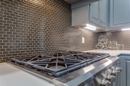 Close up of range and backsplash in modern kitchen