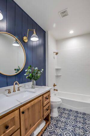 Gorgeous blue and white bathroom with decorated tile flooring