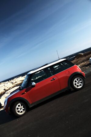 Red Mini Cooper with rich blue ocean and skyのeditorial素材