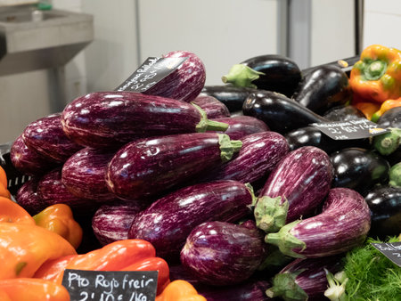 Aubergines with red and green peppers on Palma market stallの写真素材