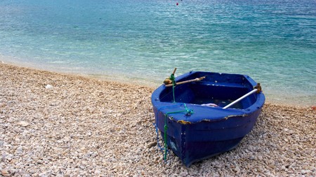 dark blue boat on the beachの写真素材