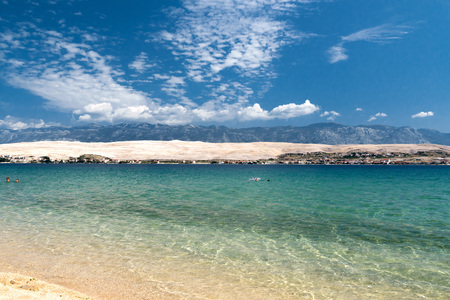 Beautiful croatian beach, mountains in the background and blue water