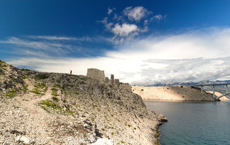 Ruine of fortress and the Pag bridge, Island of Pag, Croatia, Europeの写真素材