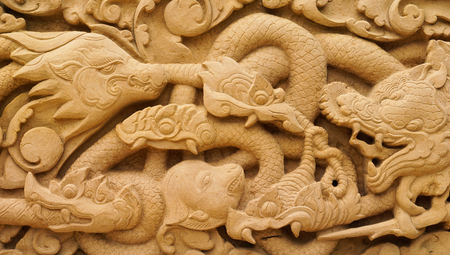carved on stone wall in thailandの写真素材