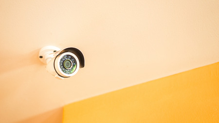 CCTV Security camera equipment on house or shop ceiling and space for text